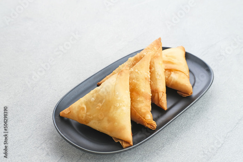 Samosa Keju, a crispy triangle fried pastry snack with cheese filling. 
 photo