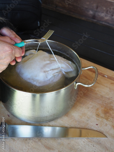 cooking cappello del prete boiled pork meat , traditional dish from Parma, Italy photo