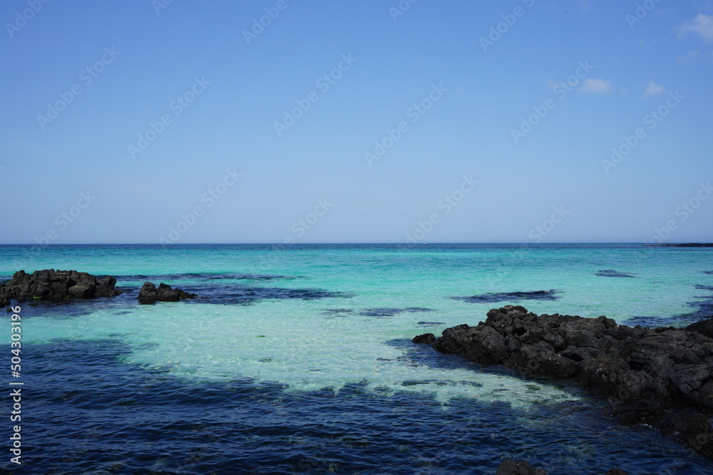 Fototapeta premium rock beach and clear bluish sea