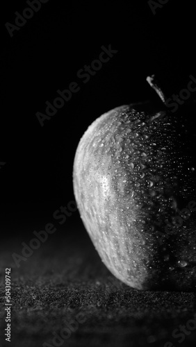 A scene of red apple on a black background at night