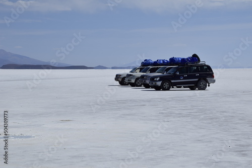 Uyuni, Bolivia - 09 february 2017: Salar de Uyuni, Bolivia. Off-road cars on the salt flat Salar de Uyuni in Bolivia