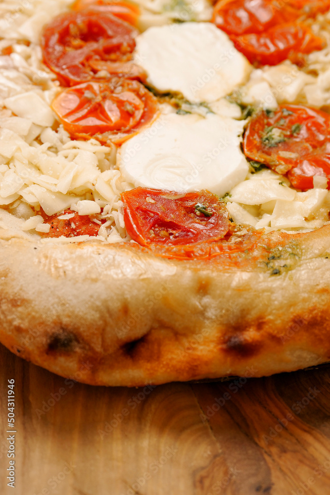 Premium high quality pizza with mozzarella cheese and tomato. Italian style dish with top products. Close up. Premium high quality pizza with mozzarella cheese and tomato. Italian style dish with top products. Close up.