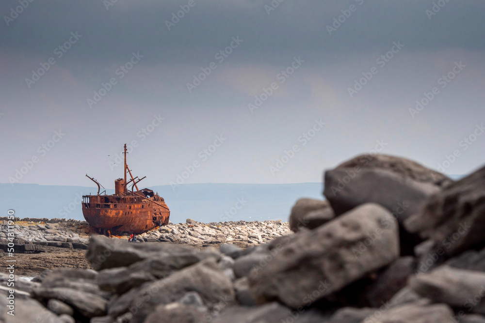 Plassey shipwreck on shore of Inisheer island. Aran islands, county Galway, Ireland. Rough stone coast with abandoned old rusty cargo ship. Popular tourist landmark and attraction. Irish landscape