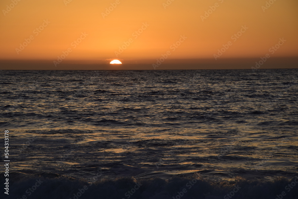 Sunset in the ocean, view from the embankment of Antofagasta, Chile.