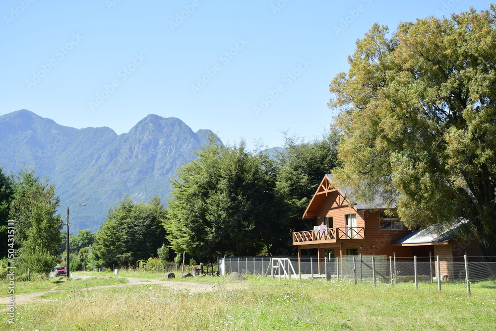 A typical wooden house with a chimney, in a small cozy town Pucon. Chile A typical wooden house with a chimney, in a small cozy town Pucon. Chile