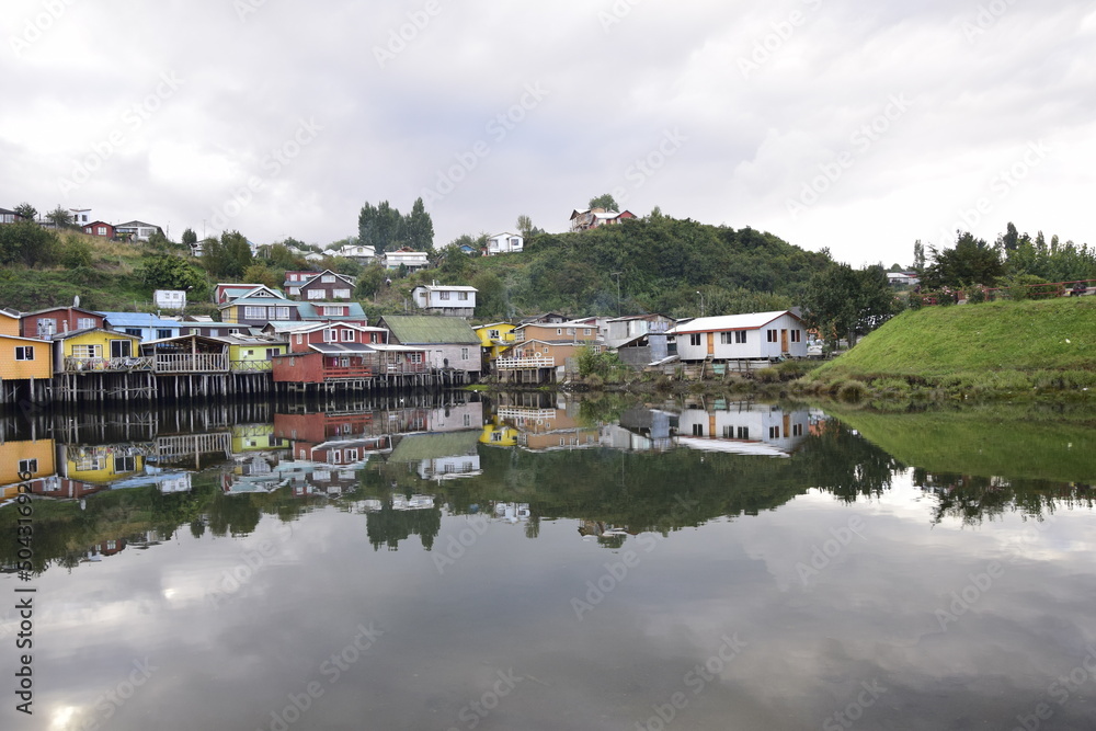 Houses on stilts (palafitos) reflected in the water in Castro, Chiloe Island, Patagonia, Chile