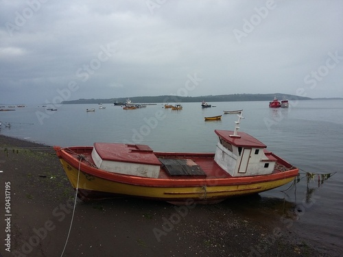 QUELLON, CHILE. Colourful fishing boats in the coastal town of Quellon on the island of Chiloe in Chile