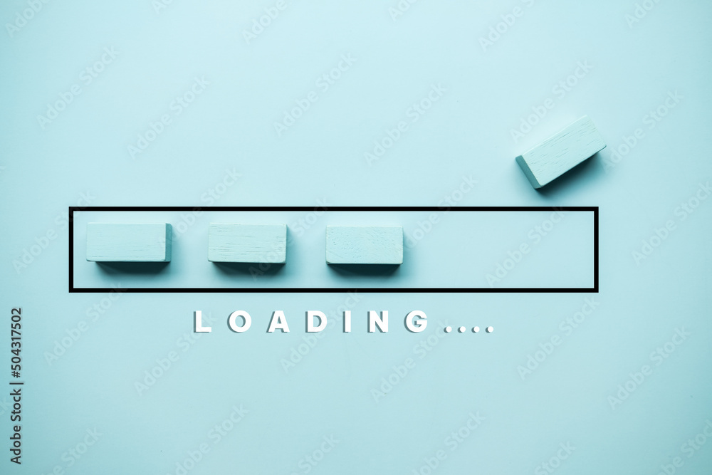 Wooden bar block to complete progress bar with the word loading. Finish working or waiting. Wooden bar block to complete progress bar with the word loading. Finish working or waiting.