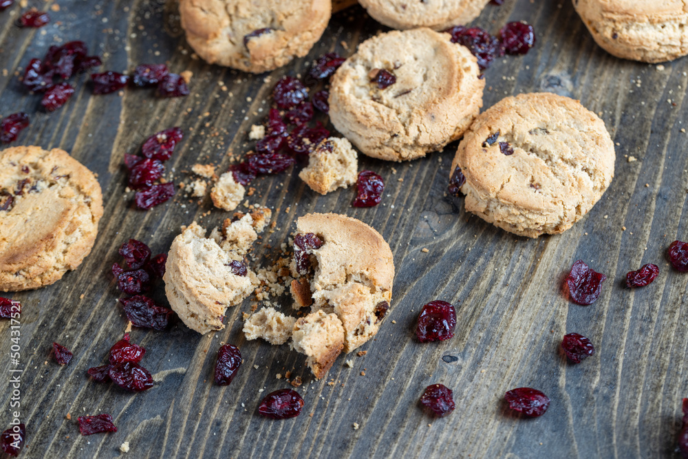 delicious dried cookies made of high-quality flour with dried red cranberries on the table delicious dried cookies made of high-quality flour with dried red cranberries on the table