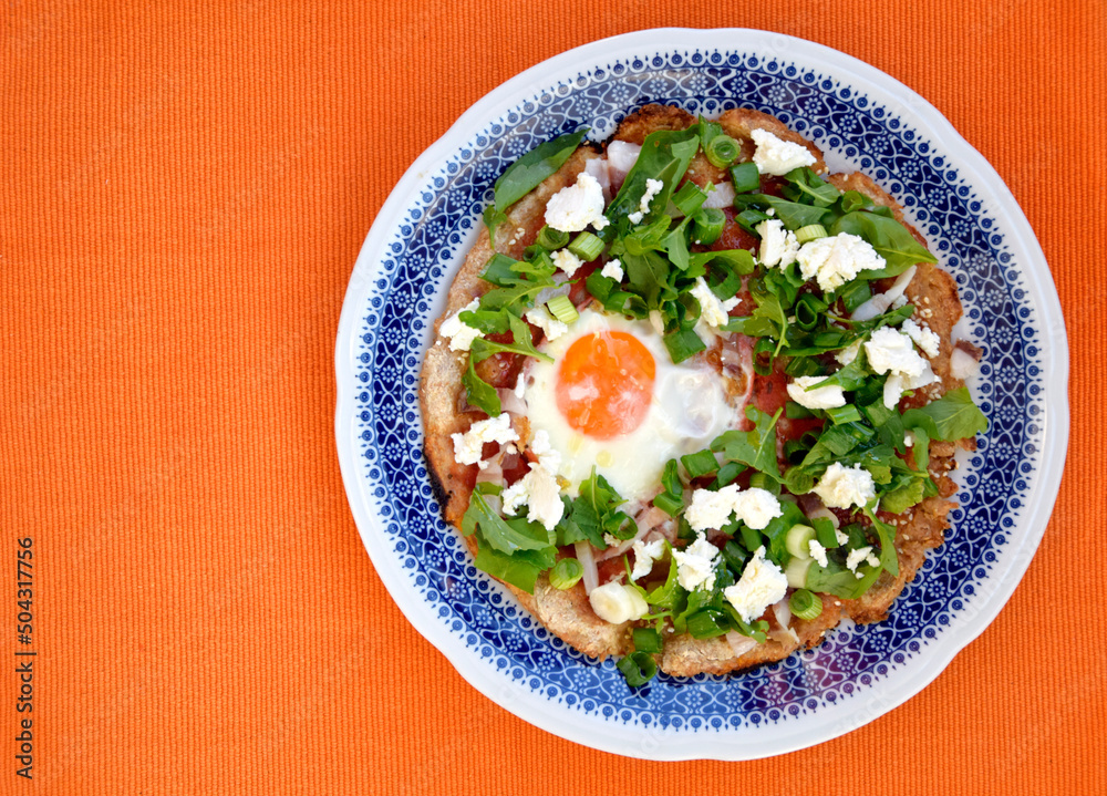 Homemade pizza, top view. Rounded pizza with egg and green vegetables Homemade pizza, top view. Rounded pizza with egg and green vegetables