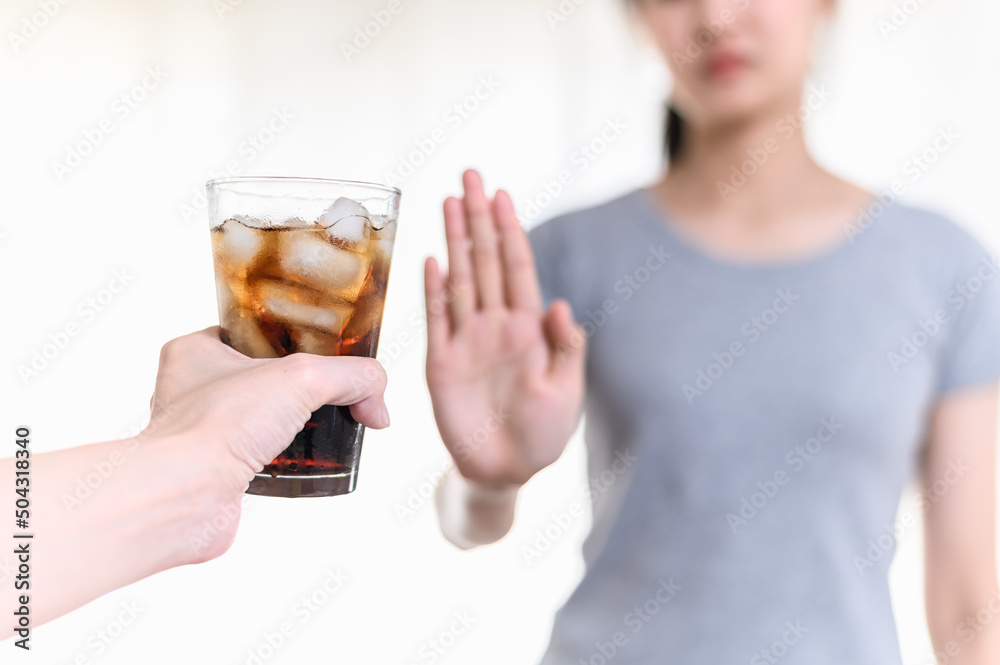 Dieting or good health concept. Young woman rejecting Junk food or unhealthy food such as sweet soda drink and choosing healthy food such as fresh fruit or vegetable. Dieting or good health concept. Young woman rejecting Junk food or unhealthy food such as sweet soda drink and choosing healthy food such as fresh fruit or vegetable.