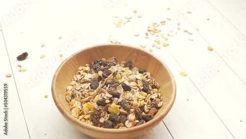 Woman hand placing a natural bowl with organic muesli