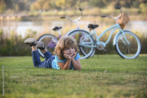 Portrait of a happy little child boy in summer park. Kids on weekend, children summer family leisure with kids. photo