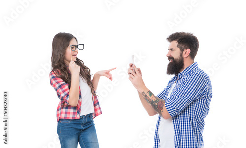 Girl child daughter with prop glasses posing for bearded man father taking photo with phone, family