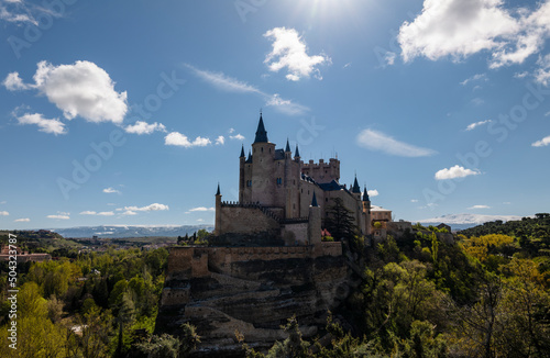 Castle of Segovia surrounding by trees against clear sky. Segovia  Spain