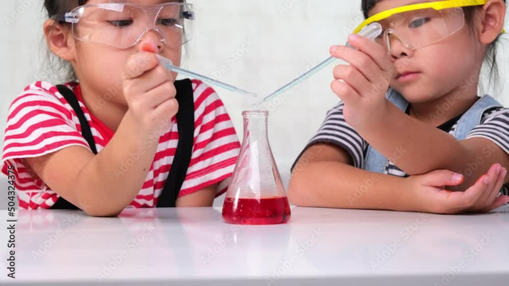 Children are learning and doing science experiments in the classroom. Two little sisters playing science experiment for home schooling. Easy and fun science experiments for kids at home. Children are learning and doing science experiments in the classroom. Two little sisters playing science experiment for home schooling. Easy and fun science experiments for kids at home.