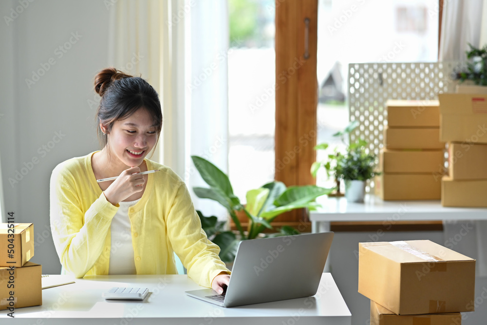 Young female startup business owner working with laptop computer for checking order on internet. Young female startup business owner working with laptop computer for checking order on internet.