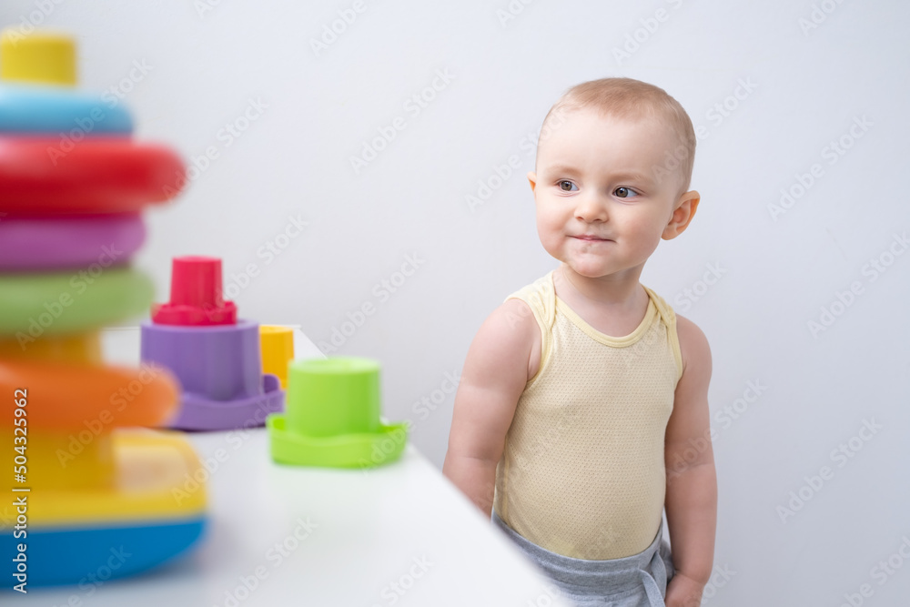 Cute kid girl playing in colorful plastic toys at home. Early childhood development Cute kid girl playing in colorful plastic toys at home. Early childhood development