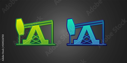 Green and blue Oil pump or pump jack icon isolated on black background. Oil rig. Vector