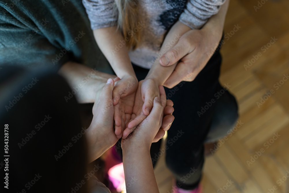 Hands of the old man and a child's hand.