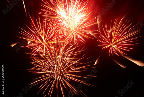 Red holiday fireworks on night black sky background