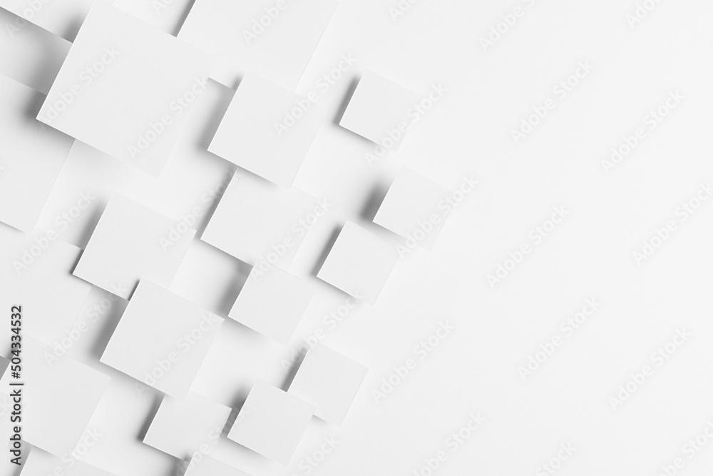Obraz premium White geometric texture with flying rhombuses in sunlight with soft grey shadows as border, copy space, top view. Simple abstract background in minimal style.