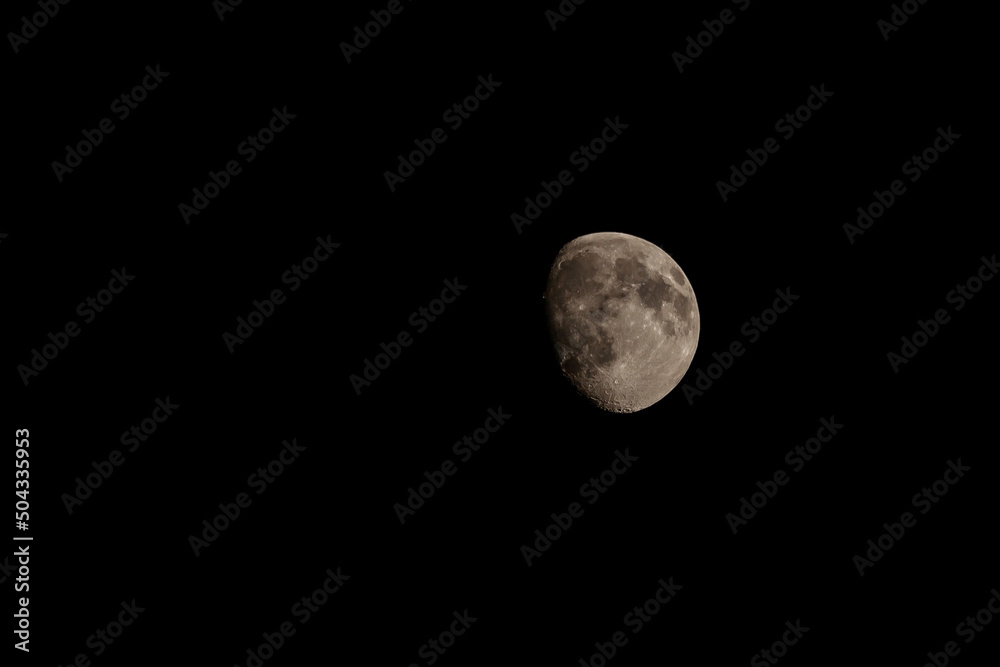 Close up of new moon with visible craters on its surface on black night sky background with copy space Close up of new moon with visible craters on its surface on black night sky background with copy space