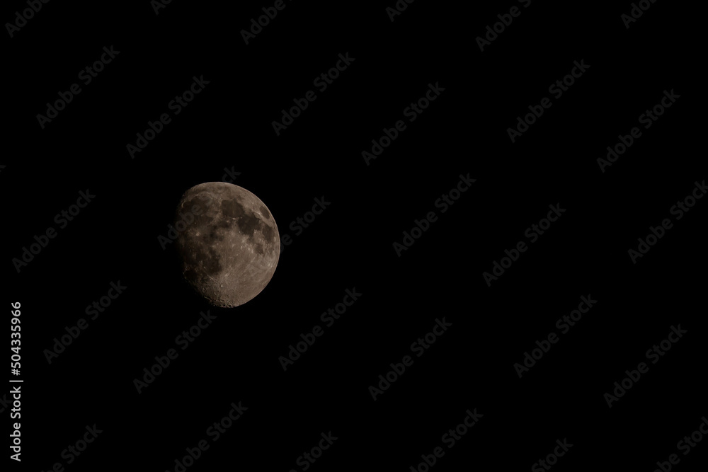 Close up of new moon with visible craters on its surface on black night sky background with copy space Close up of new moon with visible craters on its surface on black night sky background with copy space