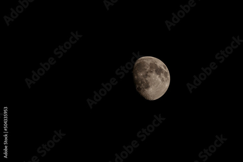 Close up of new moon with visible craters on its surface on black night sky background with copy space