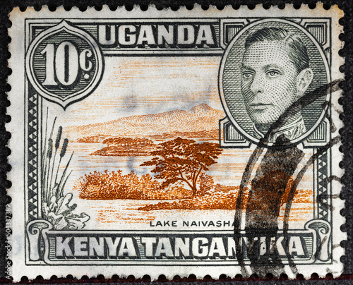 KENYA, UGANDA AND TANGANYIKA - CIRCA 19638 post stamp printed in Kenya, Uganda, Tanganyika shows lake Naivasha and portrait of king George VI Scott A14 10c ogange brown circa 1938 photo