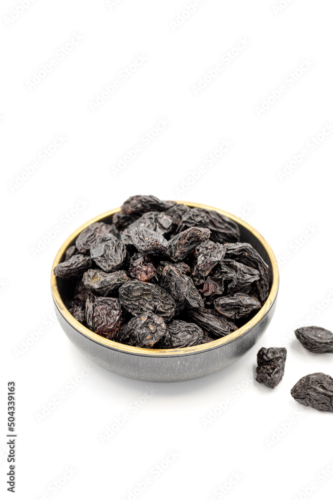 Black dried raisins on a white background. healthy and fresh.nuts. Close-up. Black dried raisins on a white background. healthy and fresh.nuts. Close-up.