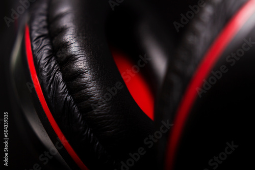 Black and red headphones on a dark background closeup