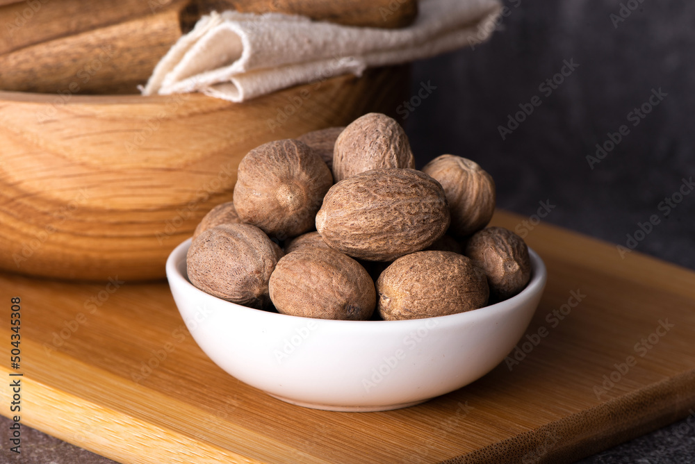 Nutmeg macro in a bowl. Nutmeg powder. Nutmeg spice.