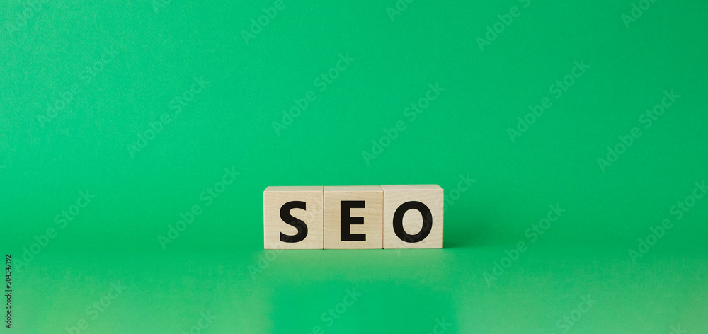 Seo symbol. Wooden blocks with words 'Seo'. Beautiful green background. Business and seo concept. Copy space. Seo symbol. Wooden blocks with words 'Seo'. Beautiful green background. Business and seo concept. Copy space.