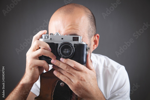  Man taking a picture with old camera.