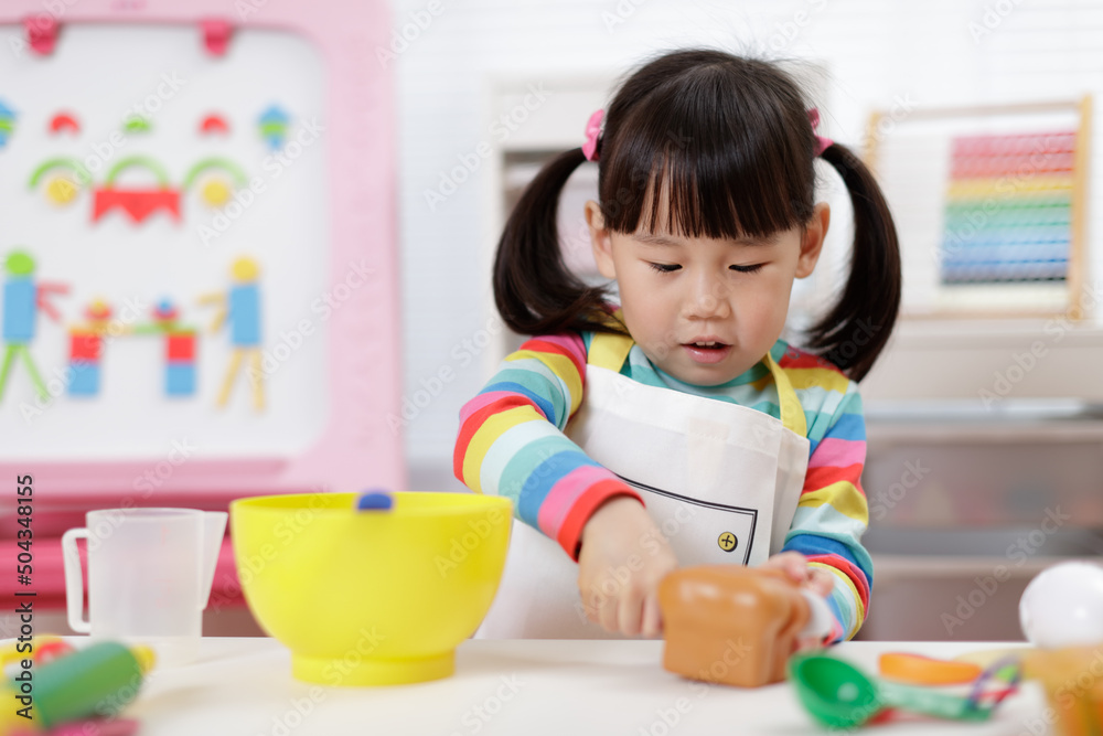 young girl pretend playing food preparing at home young girl pretend playing food preparing at home