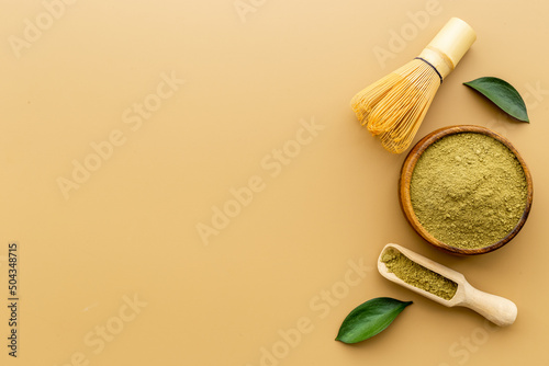 Green matcha with bamboo whisk. Powder in wooden bowl