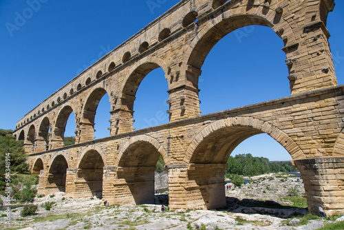 Famous Pont du Gard - an iconic Ancient Roman bridge  aqueduct and engineering masterpiece in the region Provence  France. It is formed by three floors of arcades  massive arches and pillars
