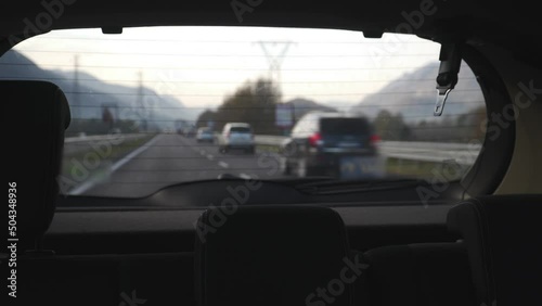 looking at a road from the back window of a car