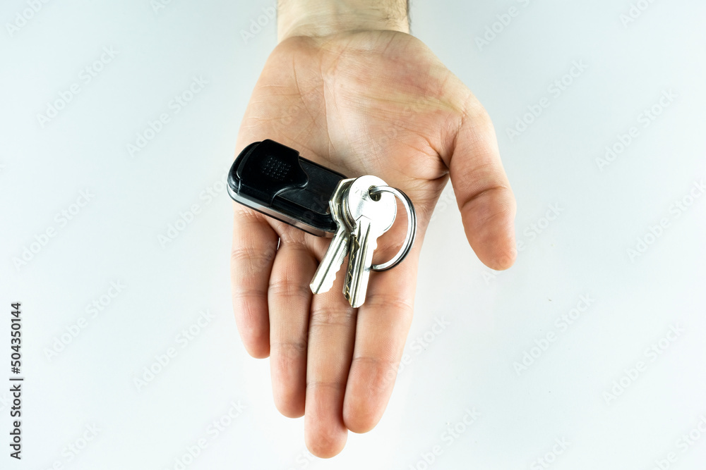 Garage door remote control on hand, isolated on white background, electric gate key, wireless RF remote control Garage door remote control on hand, isolated on white background, electric gate key, wireless RF remote control