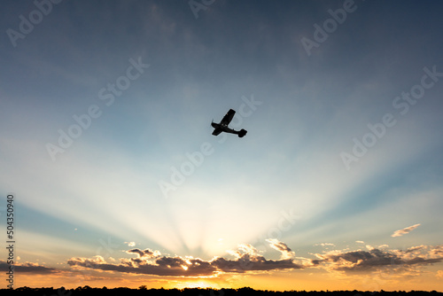Light Aircraft flying just before sunset
