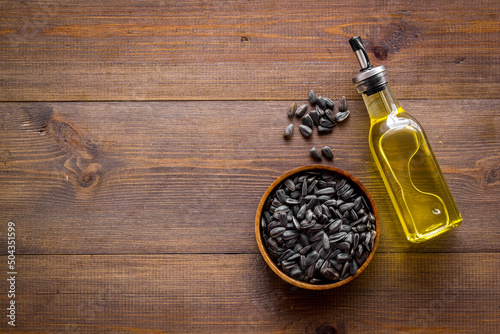 Sunflower oil in bottle with seeds. Cooking oil background