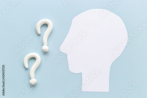 Question mark sign with paper human head. FAQ and help concept