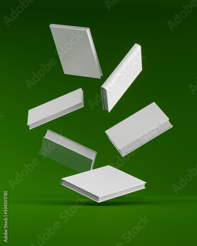 white books falling on a green surface. Blank book cover. layout or template. 3d render