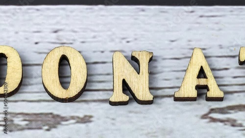 donate. Wooden letters on the office desk, informative and communication background