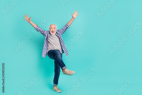 Full size portrait of impressed overjoyed person raise opened hands isolated on teal color background