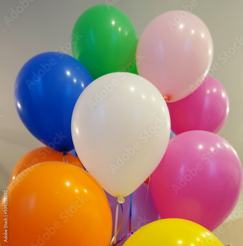 An airy white festive balloon among colorful balloons