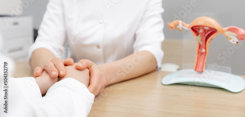 Tableau sur toile Gynecologist woman hold hand of young female patient during medical consultation in modern clinic