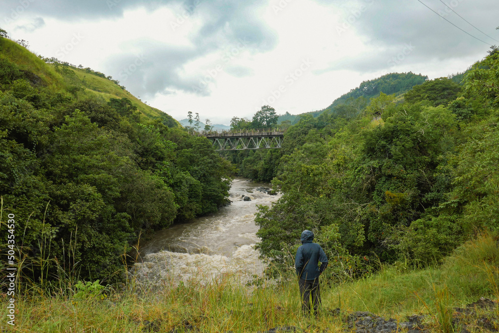 Rear view of a hiker against the background of Kiwirar River in Mbeya, Tanzania