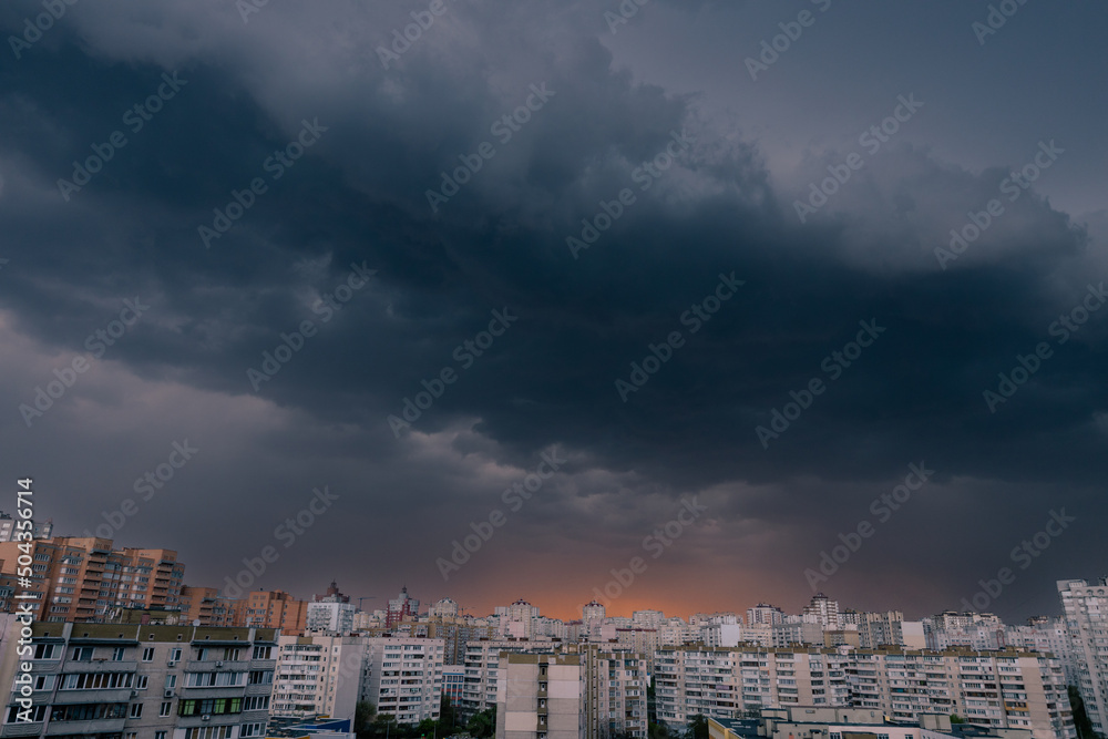 Dramatic dark stormy sky over modern city residential district.